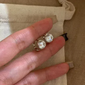 Macro view showing the sparkling zircon stone detail and silver-toned finish of the hoop earrings.