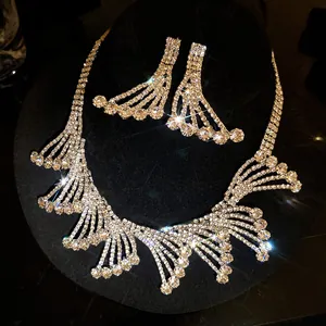 Close-up of luxurious sparkling rhinestone necklace and earrings set on black display