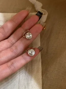 Detailed view of silver hoop earrings with brilliant-cut sparkling cubic zirconia stones.