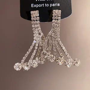 Close-up of sparkling rhinestone fringe drop earrings with elegant silver finish