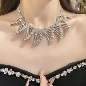 Detailed view of an exquisite rhinestone fringed collar necklace on an elegant black dress