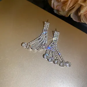 Detail of sparkling rhinestone fringe earrings with elegant hanging fan design