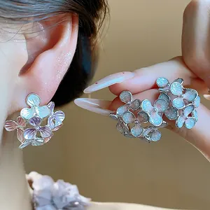 Detailed view of sweet enamel flower stud earrings with elegant glitter finish and silver posts