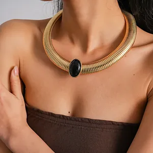 Detailed view of a retro heavy-duty gold metal choker with black oval resin stone