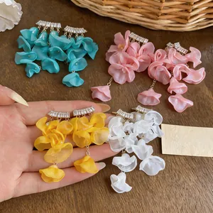 Close-up of elegant chiffon flower tassel earrings with zircon studs in four colors