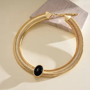 Detailed view of vintage gold metallic choker with a central black resin oval stone