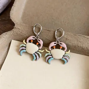 Detailed close-up showing the vibrant pastel enamel colors of cute crab-shaped hoop earrings.