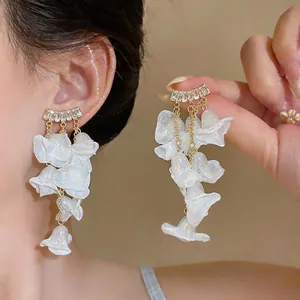 Detailed view of elegant white chiffon petal dangle earrings with zircon accents