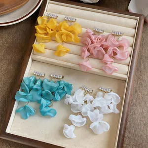 Detailed view of chiffon petal tassel earrings with zircon accents in four colors