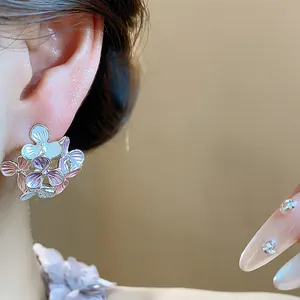 Exquisite macro detail view of colorful enamel flower stud earrings with elegant petal texture