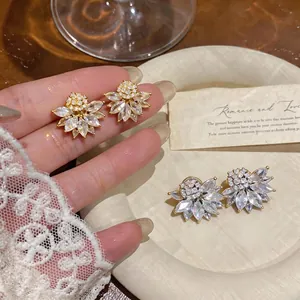 Elegant French vintage floral ear clips with sparkling crystals in gold and silver finishes.