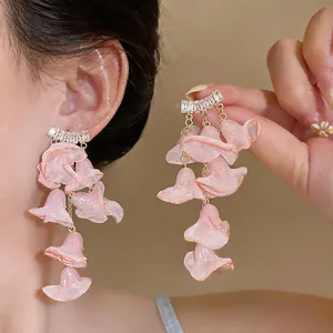 Detailed close-up of pink chiffon flower fringe earrings with zircon studs for summer