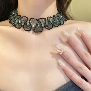 Detailed macro view of handmade beaded pearl lace choker necklace on a model's neck