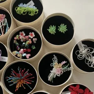 Diverse collection of colorful handmade floral beaded earrings presented in elegant gift boxes