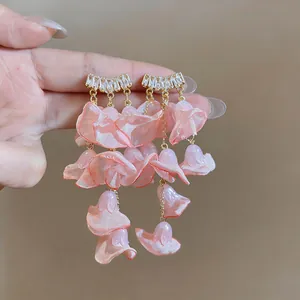 Detail of pink chiffon petal tassel earrings with sparkling zircon studs.