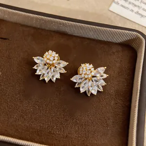 Close-up of vintage flower-shaped ear clips with sparkling marquise crystals