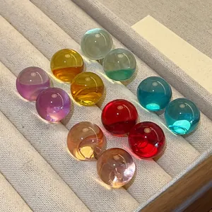 Macro view of colorful resin stud earrings with smooth finish and vibrant tones.