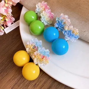 Vibrant resin flower and ball earrings in yellow blue and green vacation style studs