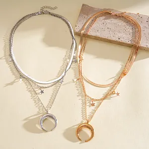 Detailed view of layered gold and silver necklaces with crescent moon and star charms.