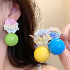 Detailed macro shot of vacation style resin flower earrings with colorful round beads
