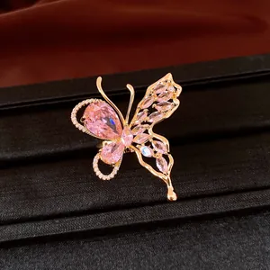 Close-up of elegant 18K gold plated butterfly earring with pink zircons on black box