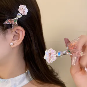 Detail showing glittery mermaid tail and pink flower hair clip with rhinestones