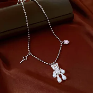 Detailed view of cute pearl bear pendant necklace featuring star and pink heart zircon