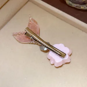 Detailed back view of an elegant pink glitter mermaid tail and flower duckbill hair clip