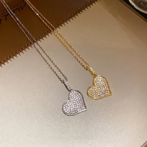 Sparkling zircon heart pendant necklace in silver and gold finishes.