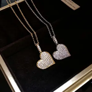 Elegant heart pendant necklace with shimmering zircon stones in gold and silver tones