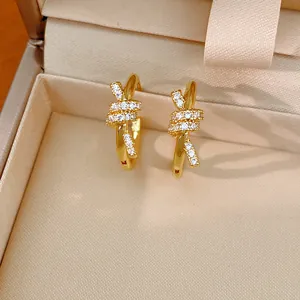 Close-up of elegant 14k gold plated knotted hoop earrings with sparkling zircon stones