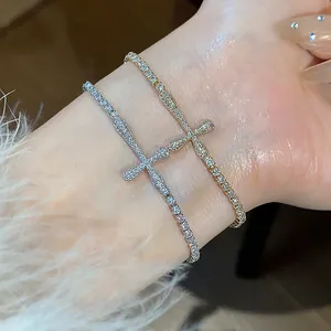 Close-up of elegant 18k gold and silver plated cross bracelets with sparkling zircon stones