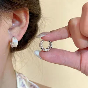 Elegant 18K gold plated brushed hoop earrings showing a textured circular design