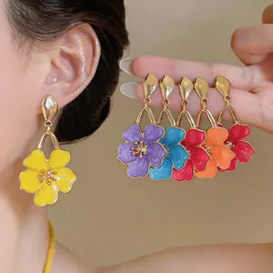 Macro view of colorful sweet style dripping oil flower drop earrings for a vibrant look