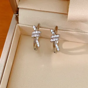 Close-up of 14k gold plated knot hoop earrings with sparkling micro-pave zircon detail