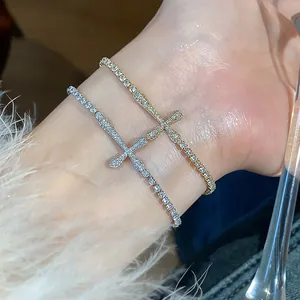 Detailed shot of 18k gold plated zircon cross tennis bracelets on a wrist