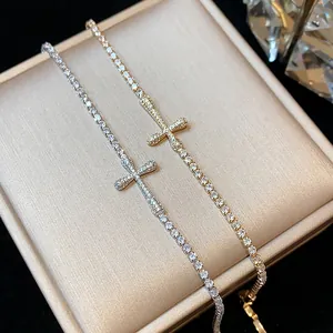 A close-up detailed view of 18k gold plated cross bracelets with shimmering zircon stones