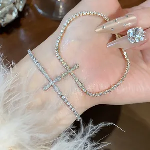 Detailed macro view of 18k gold plated cross bracelets with sparkling cubic zirconia