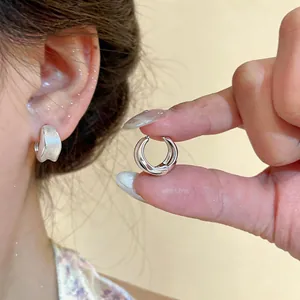 Elegant brushed silver circular hoop earrings shown in a detailed close-up view
