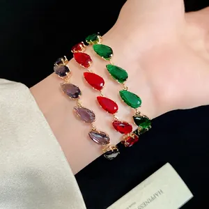 Elegant gold bracelet set with teardrop colorful zircons on wrist