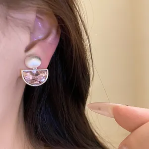 Detailed close-up showing a vintage pink crystal semicircle pendant ear clip on a model