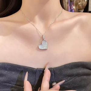 Close-up of elegant silver heart pendant necklace with shimmering zircon pavé setting