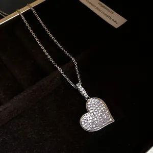 Close-up of sparkling heart pendant necklace with micro-pave zircons in black gift box