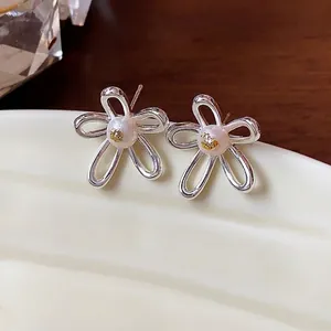 Elegant hollow flower pearl stud earrings with silver needles for a chic minimalist jewelry style