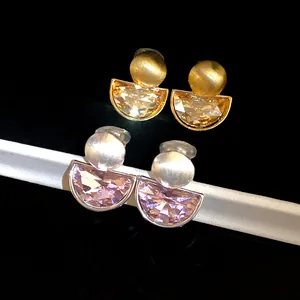 High-detail macro view of two pairs of vintage semi-circle faceted crystal drop earrings