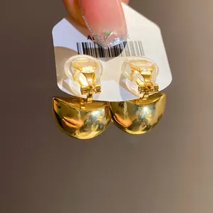Detail shot of vintage gold semi-circular clip-on earrings with soft silicone pads