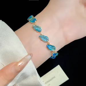 Elegant close-up of a sparkling blue waterdrop zircon bracelet on a woman's wrist