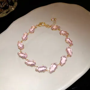 Elegant close-up view of a pink water-drop zircon bracelet with a gold-tone finish