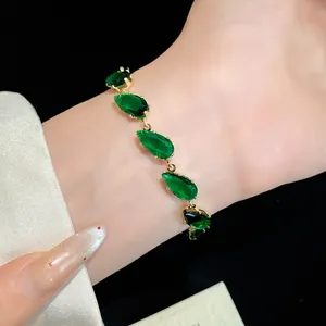 Detailed macro view of elegant emerald green pear-cut zircon bracelet worn on a wrist