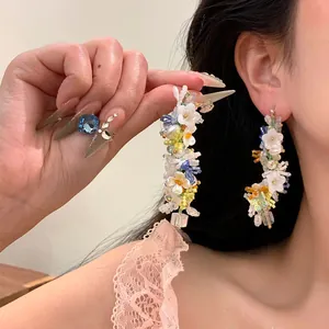Elegant handmade floral beaded drop earrings in Monet's Garden style shown on ear